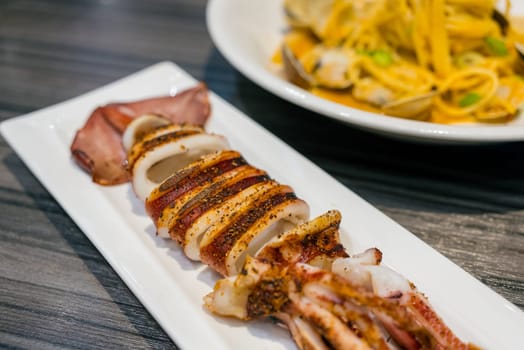 Grill squid on white plate