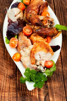 Roasted chicken pieces and salad. Flat lay with copy space.