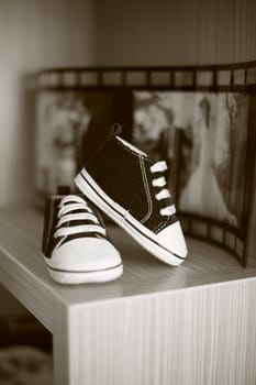Black and white photo of very small children's sneakers