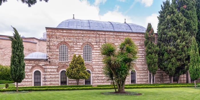 16th century Ottoman era Agalar Mosque with red bricks and distinctive blue roof located in the courtyard of Topkapi Palace, Istanbul, Turkey