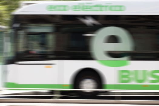 Valladolid, Spain: July 17th, 2020: Eco-Electric urban bus circulating along Valladolid streets. Motion blurred shot