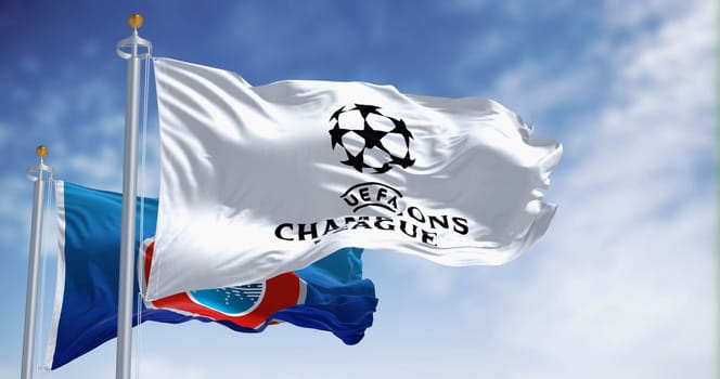 London, UK, Dec 1 2023: UEFA and UEFA Champions league flags waving together. European football competition. Rippled fabric. Illustrative editorial 3d illustration render. Selective focus