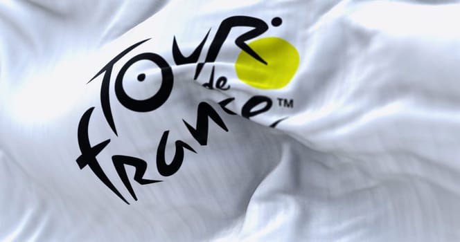 Paris, FR, Dec 2 2023: Close-up of Tour de France flag waving in the wind. Most important international cycling event of the year. Illustrative editorial 3d illustration render. Selective focus