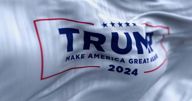 Arlington, US, OCT. 21 2023: Close-up of Donald Trump election campaign flag waving on a clear day. 2024 US presidential election. Illustrative editorial 3d illustration render. Selective focus