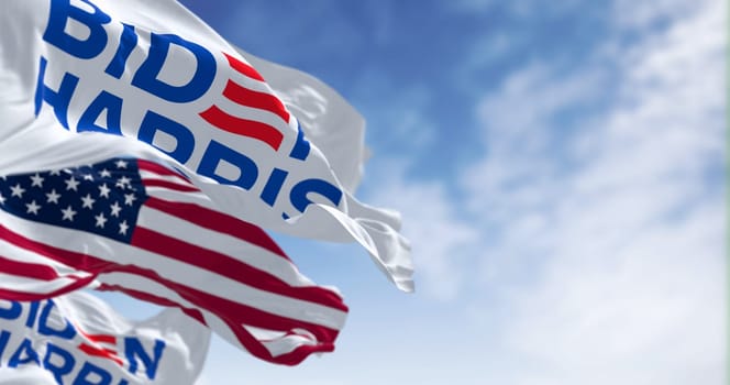 Washington D.C., US, June 20 2023: Biden Harris 2024 presidential campaign flag waving with the american flag. Illustrative editorial 3d illustration render. 2024 US presidential election