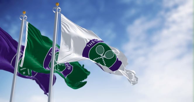 London, UK, July 3 2023: The Championships Wimbledon flags waving on a clear day. Wimbledon Championships is a major tennis tournament. Illustrative editorial 3d illustration render.