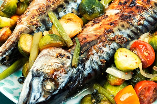 Baked mackerel fish and tomatoes, cabbage and green beans. Tasty fish, seafood.