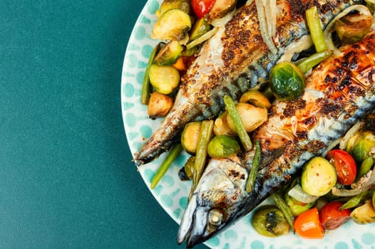 Baked mackerel fish and tomatoes, cabbage and green beans. Tasty fish, seafood.