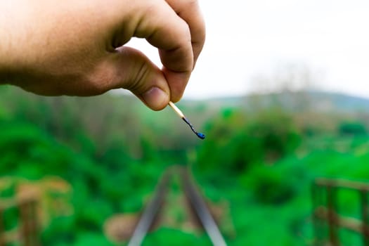 Matches on a rails railroad tracks background, fire on railways concept