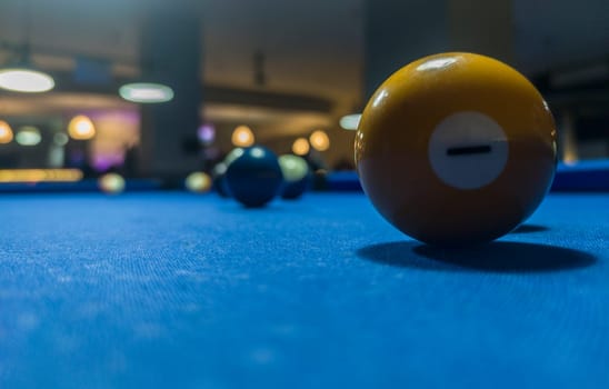 Yellow solid ball. Eight-ball pool game at six pocket blue table.