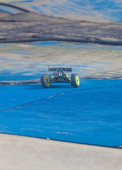 Merida, Spain - Jan 28th, 2024: Extremadura 1/8tt gas Championship RC Car. Cars making a curve over blue turf