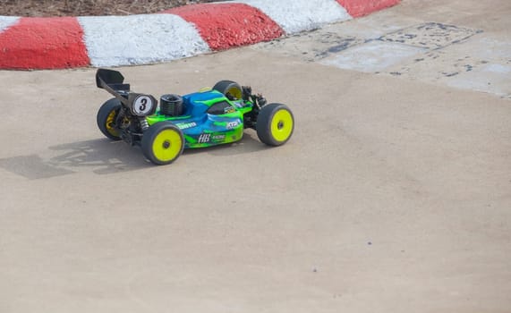 Merida, Spain - Jan 28th, 2024: Extremadura 1/8tt gas Championship RC Car. Cars making a curve over concrete surface