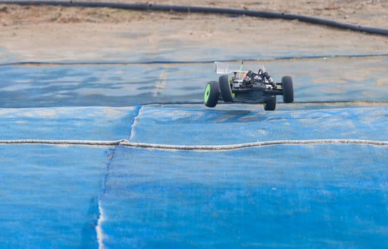 Merida, Spain - Jan 28th, 2024: Extremadura 1/8tt gas Championship RC Car. Jumping over blue turf