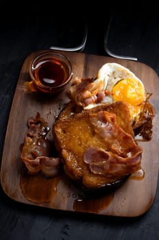 close up of rustic french toast with bacon and egg