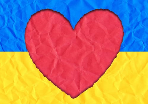 Scrap of paper in the shape of a heart in the colors of the Ukrainian flag, copy space