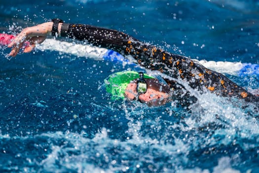 Crawl swimmer in a pool, wearing a wetsuit