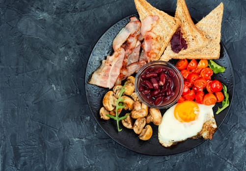 English breakfast with fried eggs and bacon. Close up.