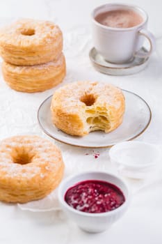 Cronuts - delicious fusion of croissant and donut with raspberry jam. Half-donut and half-croissant pastry