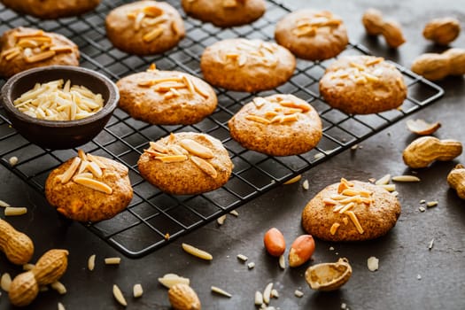 Homemade peanut butter cookies with almond on dark background