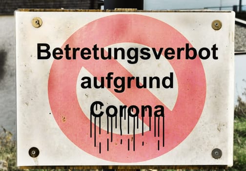 An old sign with a ban on entering due to Corona