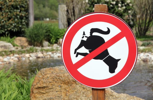 Funny dog poop prohibition sign, with a dog pooping upwards as a rocket