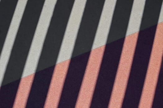 pattern of diagonal stripes with different colors and textures. The upper part has smooth grey and black stripes, while the lower part has textured pink and purple stripes.