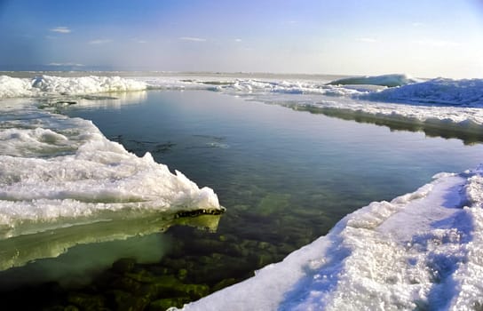 Winter on the Baikal, ice and snow on the lake. The beauty of the nature of Baikal in winter.
