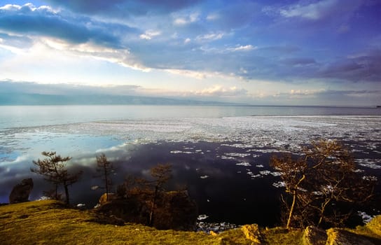 Spring on Baikal, ice and snow on the lake melt. The beauty of the nature of Baikal in the early spring.
