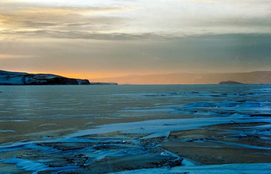 Winter on the Baikal, ice and snow on the lake. The beauty of the nature of Baikal in winter.