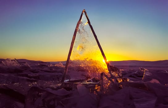 Frozen icicles of fresh water of lake Baikal. Winter on the Baikal, ice and snow on the lake. The beauty of the nature of Baikal in winter.