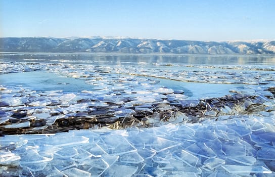 Winter on the Baikal, ice and snow on the lake. The beauty of the nature of Baikal in winter.