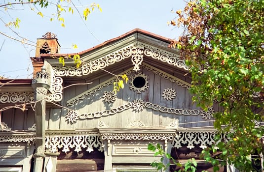 Plinths of windows of wooden houses. Ancient style of decoration of window frames.