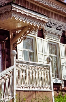 Plinths of windows of wooden houses. Ancient style of decoration of window frames.