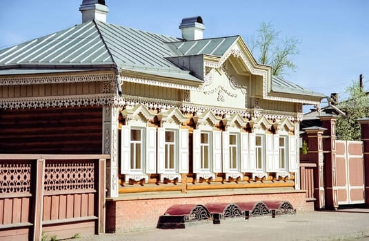 Plinths of windows of wooden houses. Ancient style of decoration of window frames.