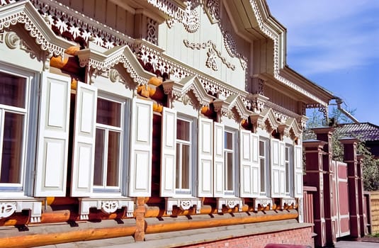 Plinths of windows of wooden houses. Ancient style of decoration of window frames.
