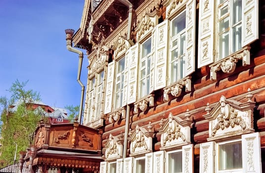 Plinths of windows of wooden houses. Ancient style of decoration of window frames.