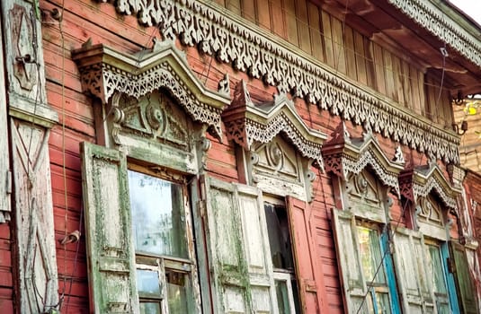 Plinths of windows of wooden houses. Ancient style of decoration of window frames.