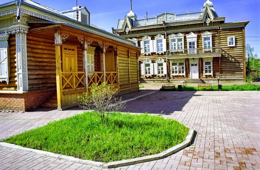 Plinths of windows of wooden houses. Ancient style of decoration of window frames.