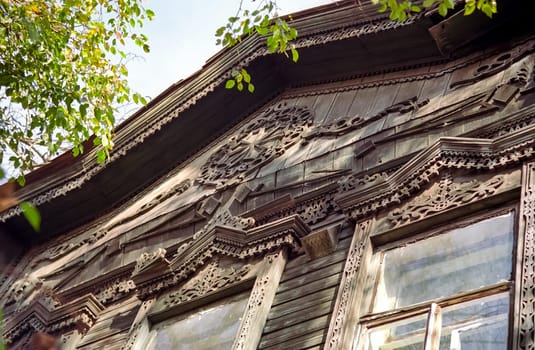 Plinths of windows of wooden houses. Ancient style of decoration of window frames.