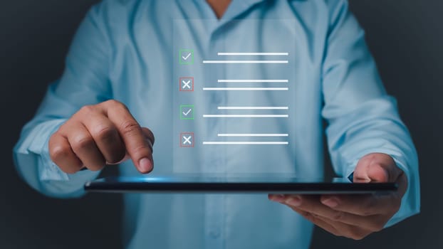 Checklist and filling survey form online. Document management system, DMS. Quality control and accuracy Check, Businessman using tablet online survey filling out, Business performance monitoring.