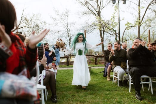 wedding ceremony of the newlyweds in a country cottage on a green hill
