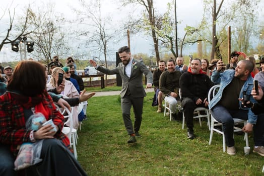 wedding ceremony of the newlyweds in a country cottage on a green hill