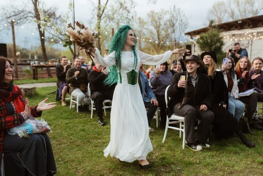 wedding ceremony of the newlyweds in a country cottage on a green hill