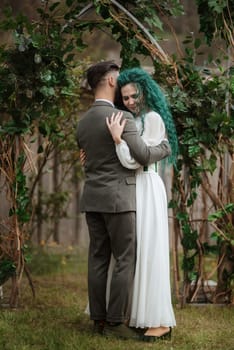 wedding ceremony of the newlyweds in a country cottage on a green hill