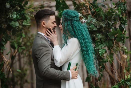 wedding ceremony of the newlyweds in a country cottage on a green hill