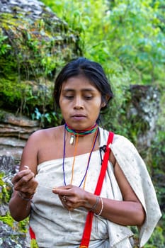 Tayrona, Magdalena, Colombia - September 21 2023: Indigenous Koguis shaman wife in Ciudad Perdida, Magdalena, Sierra Nevada de Santa Marta, Colombia