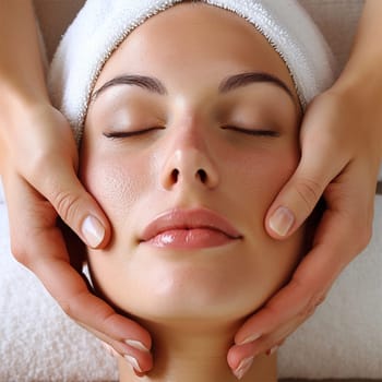 cosmetic massage face .Woman enjoying a facial massage at a spa.