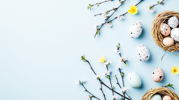 Easter eggs and cherry blossoms in pastel colors on a soft blue background , space for text