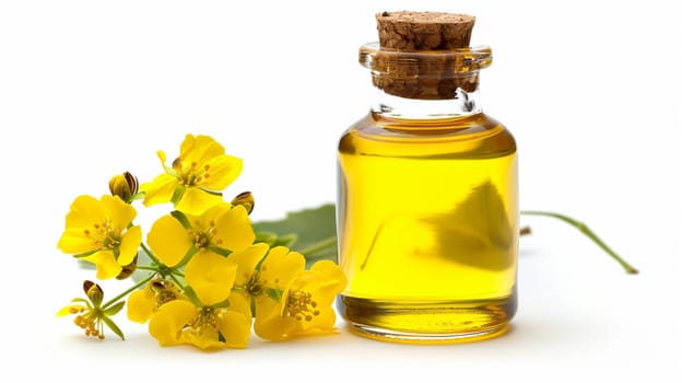 Bottle of golden essential oil with blooming yellow flowers.