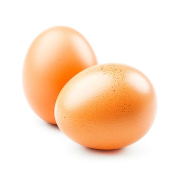 Close-up of two brown eggs isolated on a pure white background, symbolizing freshness and organic produce.